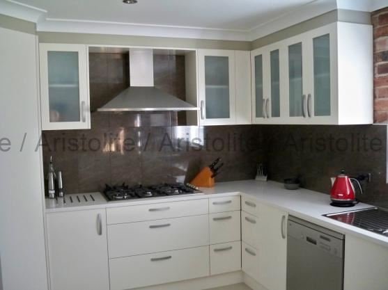 L Shaped Kitchen Design by Aristolite with modern finishes