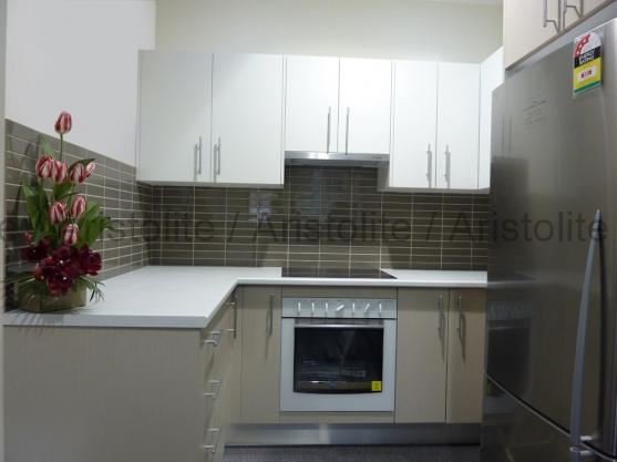 L Shaped Kitchen Design by Aristolite with modern finishes