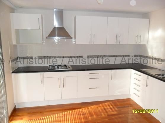 L Shaped Kitchen Design by Aristolite with modern finishes