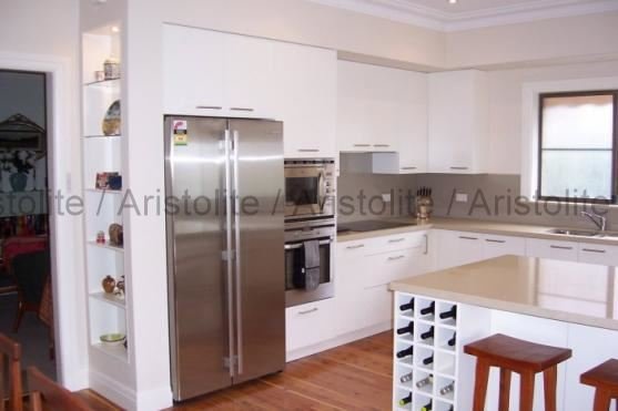 L Shaped Kitchen Design by Aristolite with modern finishes