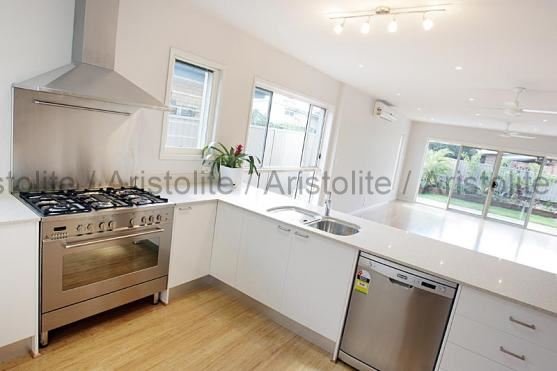 L Shaped Kitchen Design by Aristolite with modern finishes