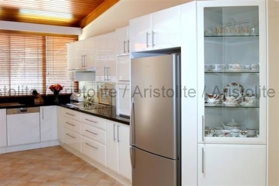 L Shaped Kitchen Design by Aristolite with modern finishes