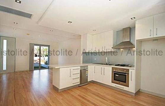 L Shaped Kitchen Design by Aristolite with modern finishes