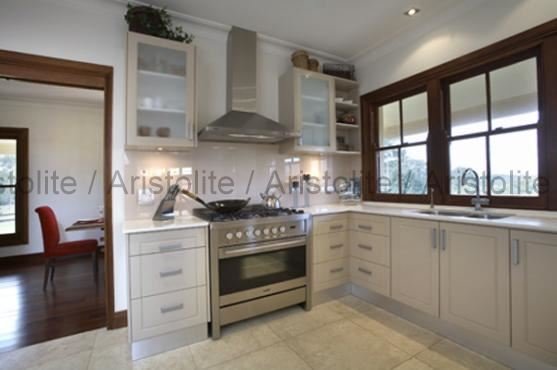 L Shaped Kitchen Design by Aristolite with modern finishes