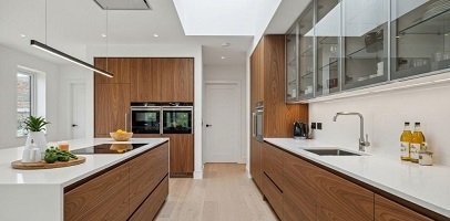 Contemporary parallel kitchen design with glossy cabinets and modern finish